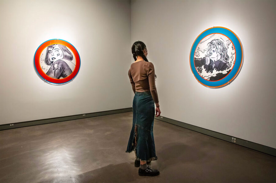 a woman looking at a picture on a wallA Radical Vision, Remembering Dara Birnbaum’s Groundbreaking Legacy in Video Art